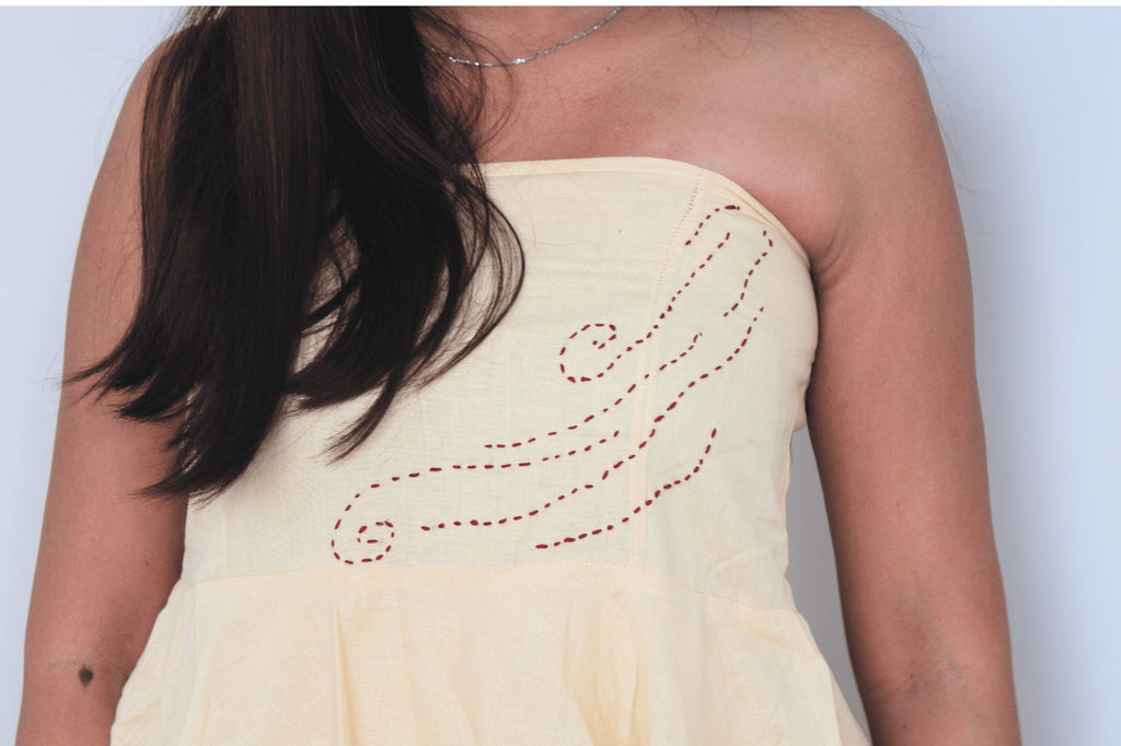 Light yellow strapless dress with red embroidery