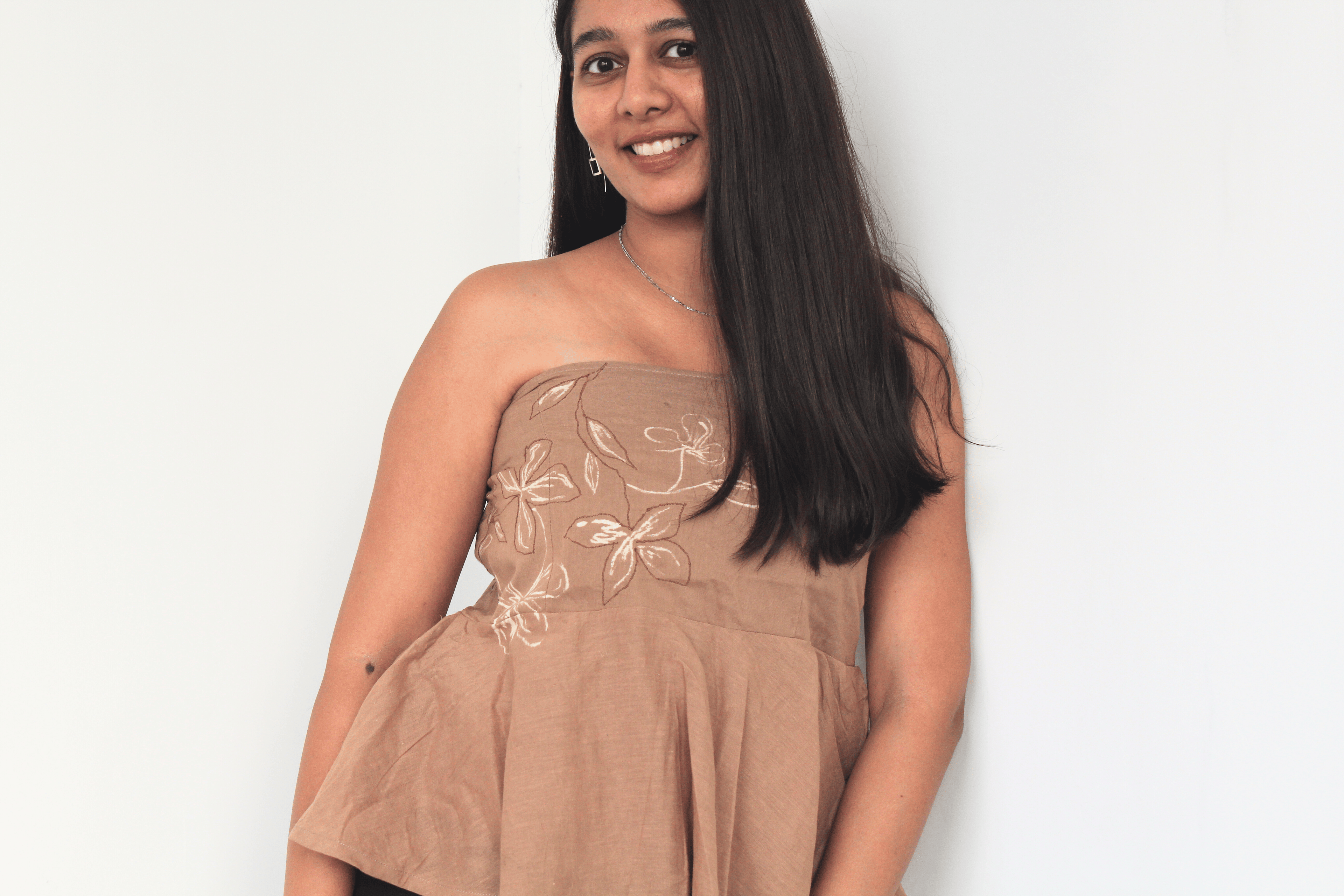 Woman wearing a pure cotton tube top for women with hand drawn artwork, breathable strapless summer top for casual and vacation wear.