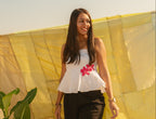 Woman wearing a strapless floral summer top with handcrafted flower accents, lightweight tube top for warm weather styling.