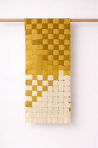 Handmade woven cotton table runner featuring a geometric square weave pattern, decorative table linen for dining table styling.