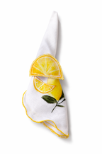 White napkin with lemon design napkin holder on a white background