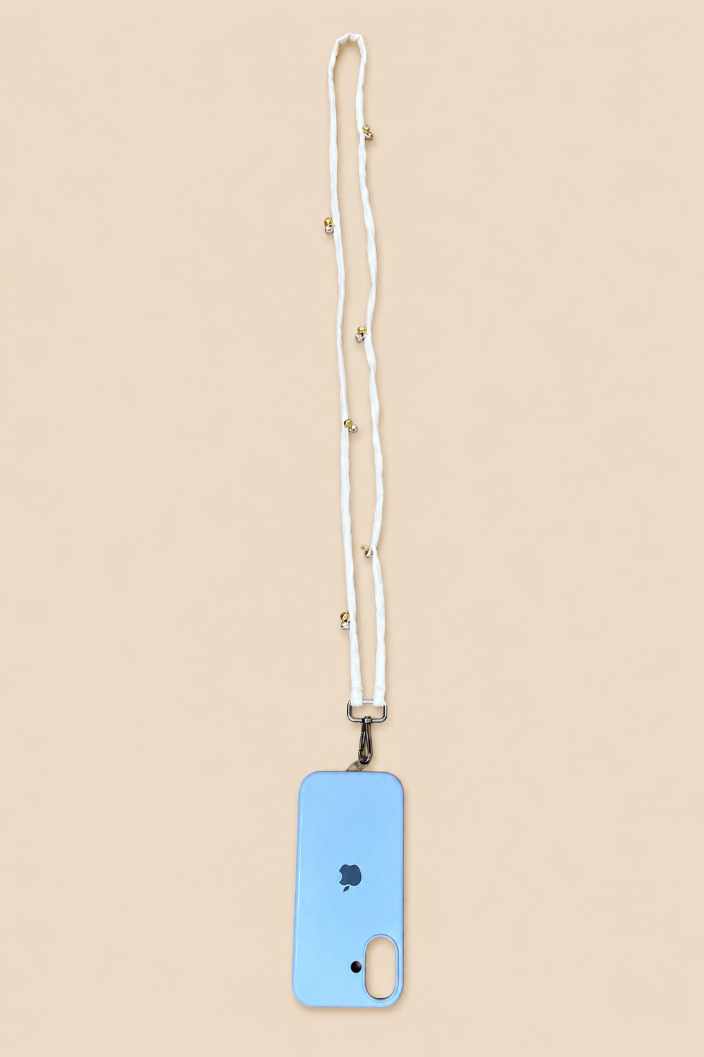 A light blue phone case with a white woven lanyard strap featuring small gold beads, shown on a solid beige background.